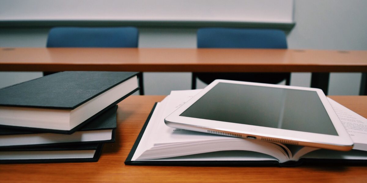 Tablet on top of books on a classroom table