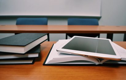 Tablet on top of books on a classroom table