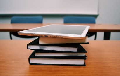 Tablet on top of books on a desk