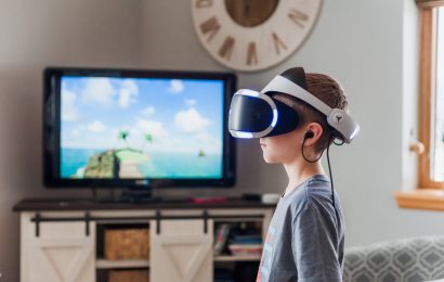 Boy using virtual reality (VR) goggles for story