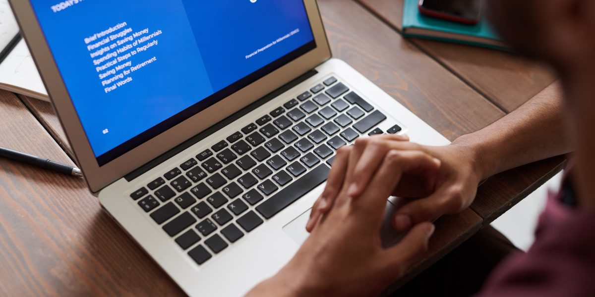 Student reading outline on his laptop